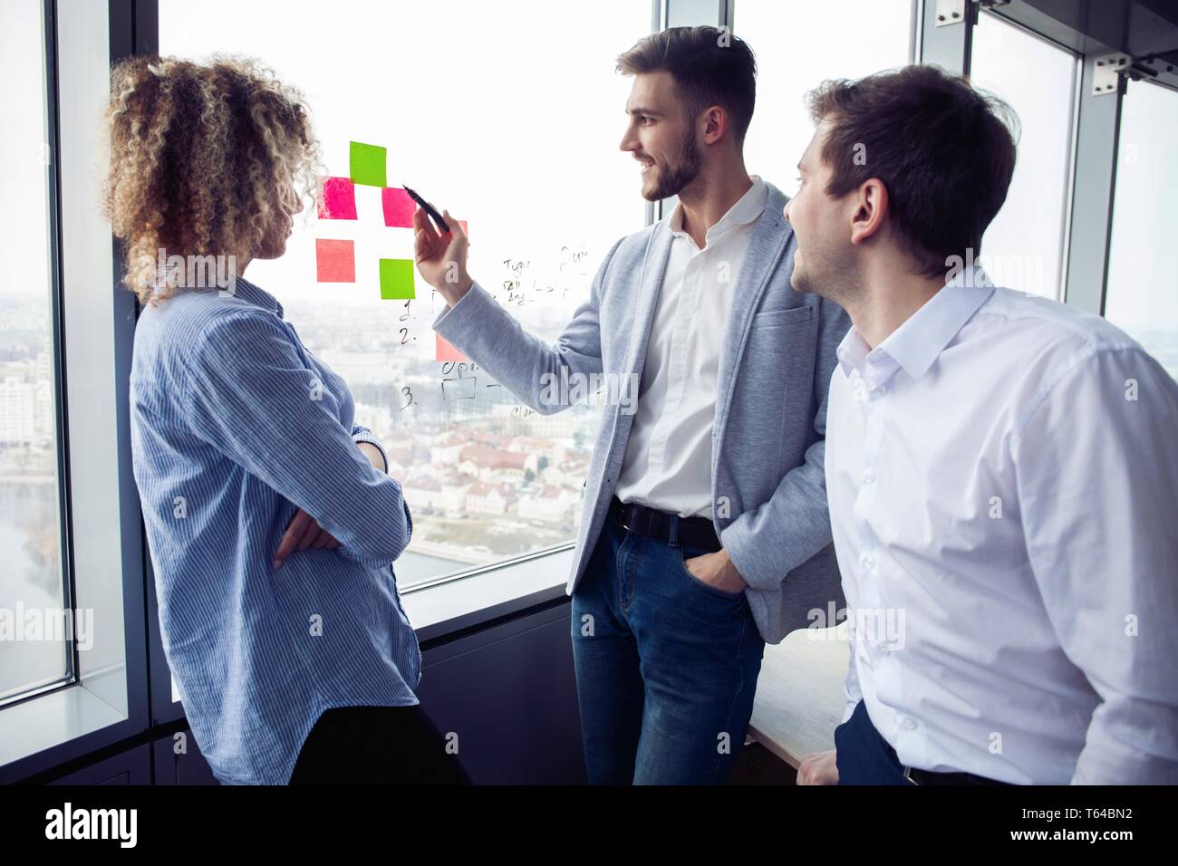 Grupo de jóvenes emprendedores están buscando una solución de negocios durante el proceso de trabajo en la oficina.La gente de negocios concepto de reunión Foto de stock