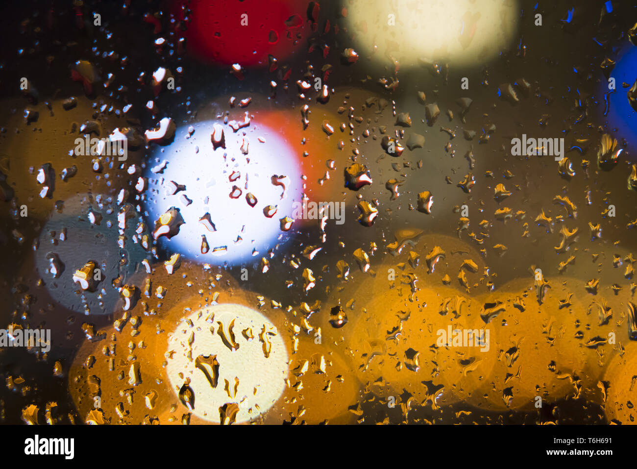 Gotas de agua en la ventana con fondo de color Foto de stock