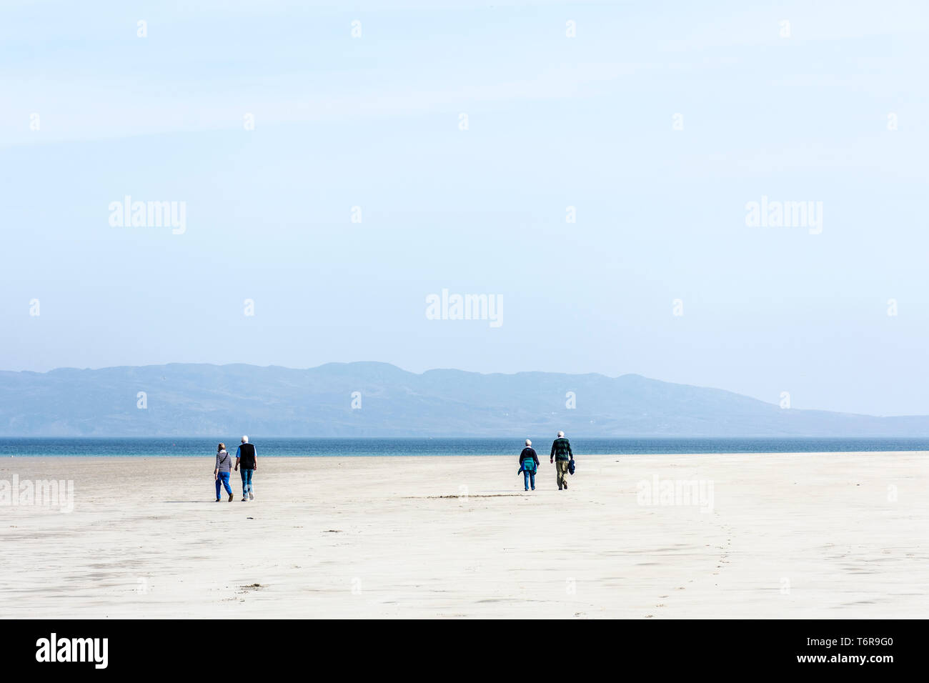Dos parejas senior en la playa caminando, en el condado de Donegal, Irlanda Foto de stock