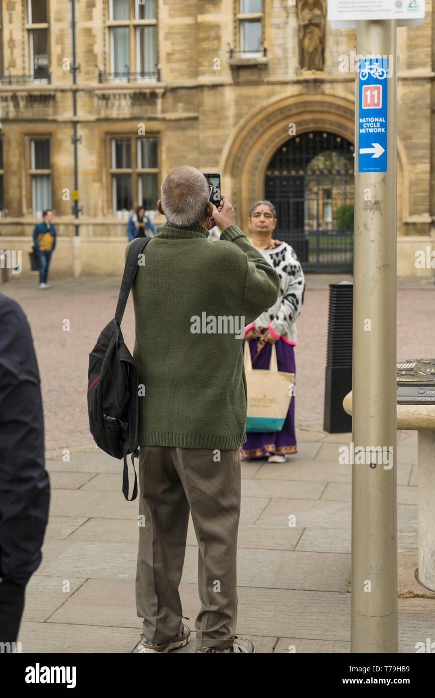 Hombre asiático tomando una foto de la mujer asiática Cambridge 2019 Foto de stock