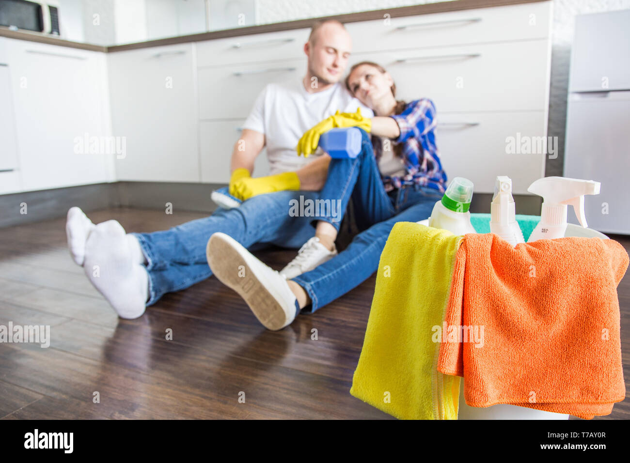 Pareja joven esposo y esposa hacen la limpieza de la casa. Chico y chica  lavar la cocina con un trapeador y trapo, trabajo en equipo, la diversión  Fotografía de stock - Alamy