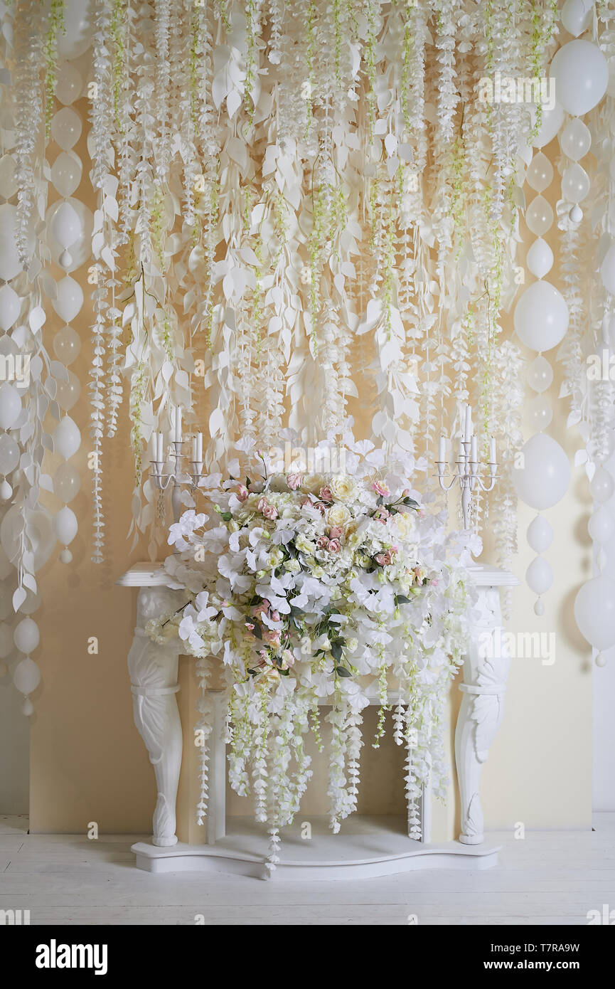 Guirnalda de flores en la pared como un elemento de decoración, bodas,  fiestas. Tono de luz.la chimenea decorativa Fotografía de stock - Alamy