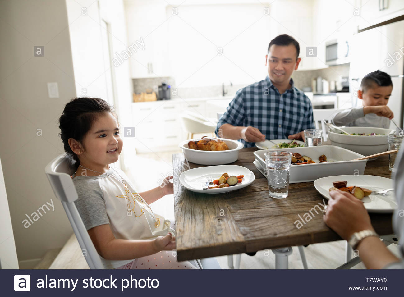 Familia disfrutando de la cena en la mesa Foto de stock