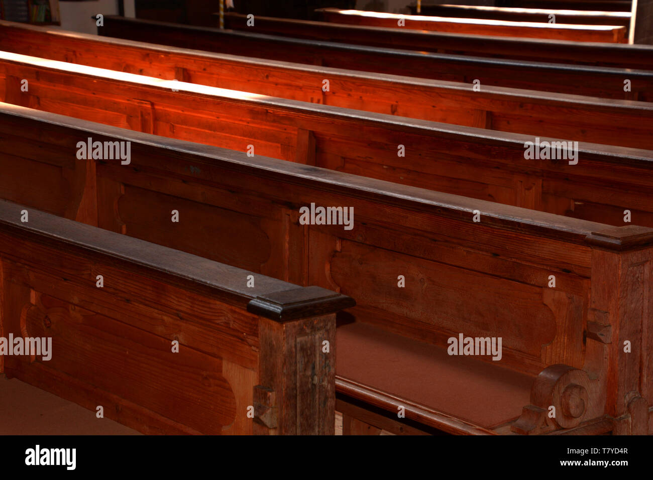 Antigua iglesia de madera vacías y bancas sin gente en Baviera, filas de  bancos de iglesia de madera iluminados por el sol a través de la iglesia  windows Fotografía de stock -