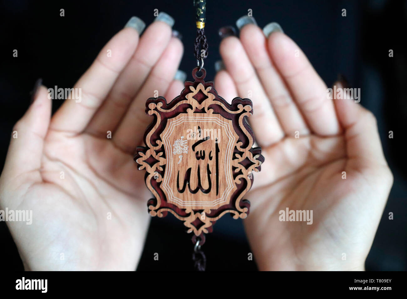 Close-up de la palabra Alá en árabe la caligrafía y la mujer orando, Vietnam, Indochina, en el sudeste de Asia, Asia Foto de stock