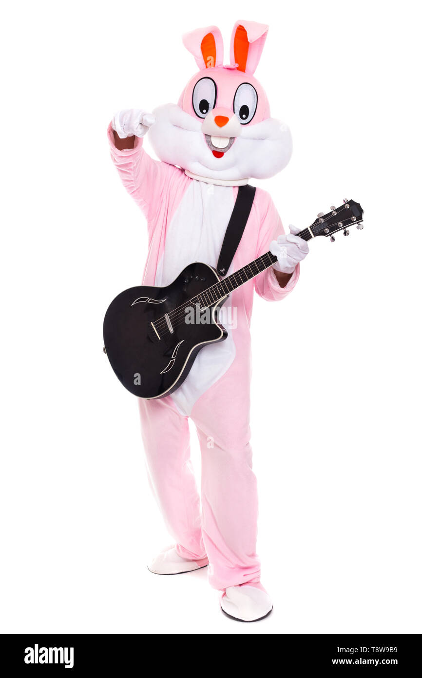El hombre en la vida tamaño traje de conejito de Pascua reproduce música en guitarra. Gracioso la liebre o el conejo guitarrista sonríe, reproducir canciones Foto de stock
