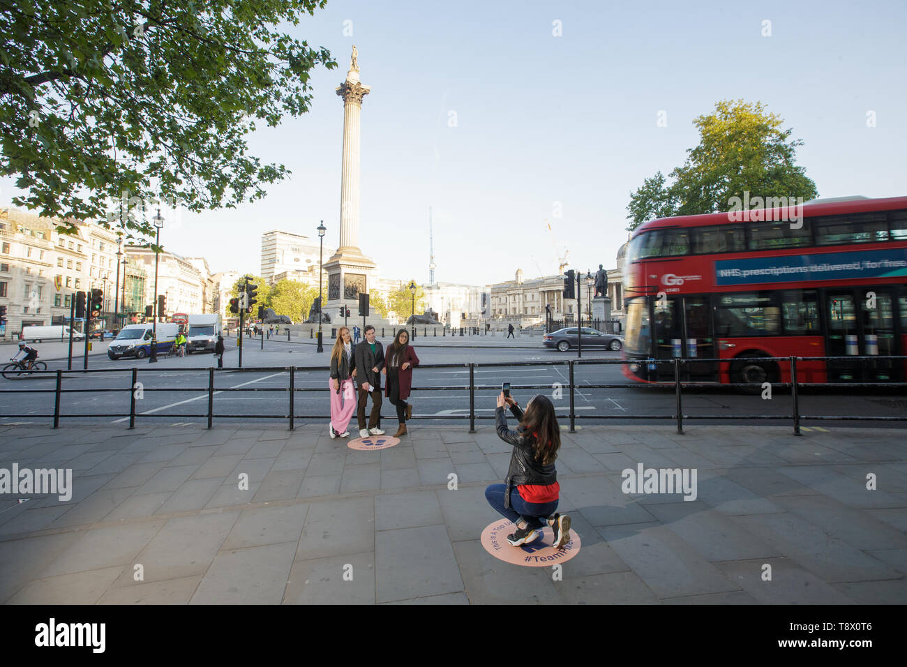 Los turistas tienen su foto tomada en Trafalgar Square en Londres, como Google ha trazado exactamente donde encaje la nación favorita de fondos fotográficos para celebrar el lanzamiento de pixel 3a. Foto de stock