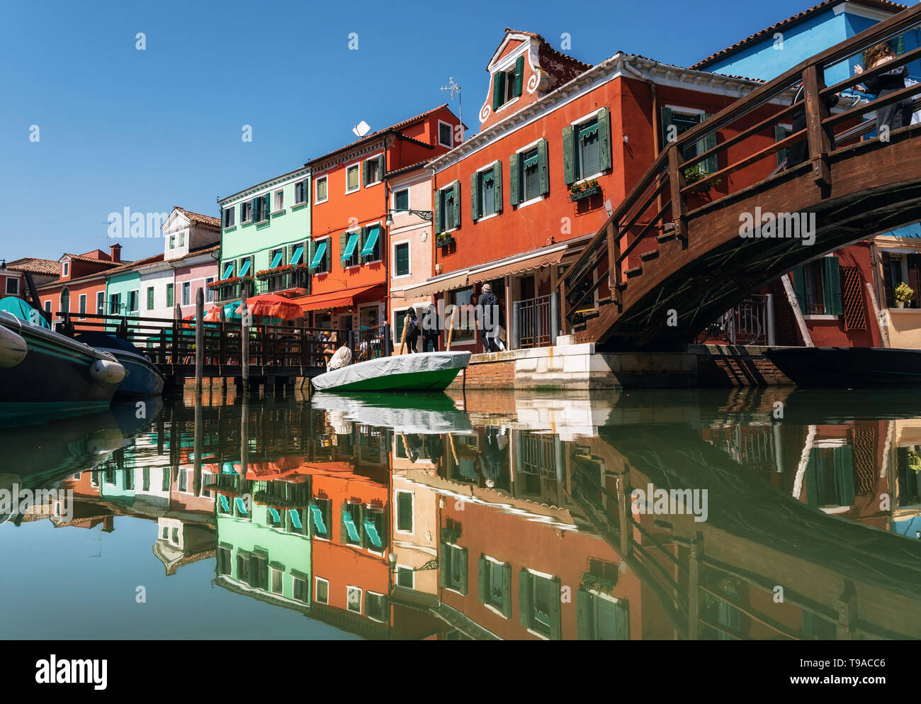 Coloridas casas en Burano con reflejo en el canal de Venecia, Italia Foto de stock