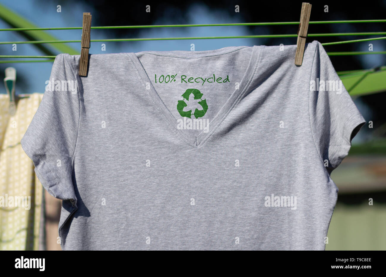 Reciclar ropa icono en camiseta con texto 100% reciclado, ilustración del concepto reutilizar, reciclar ropa y textiles para reducir los residuos Foto de stock