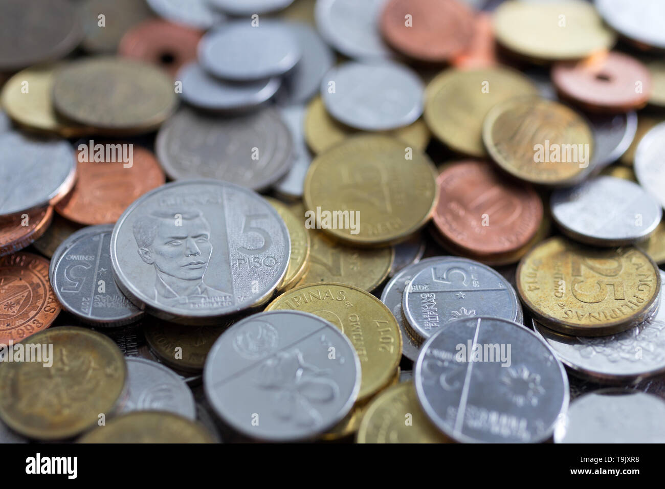 Un montón de nuevos y viejos peso filipino monedas Foto de stock