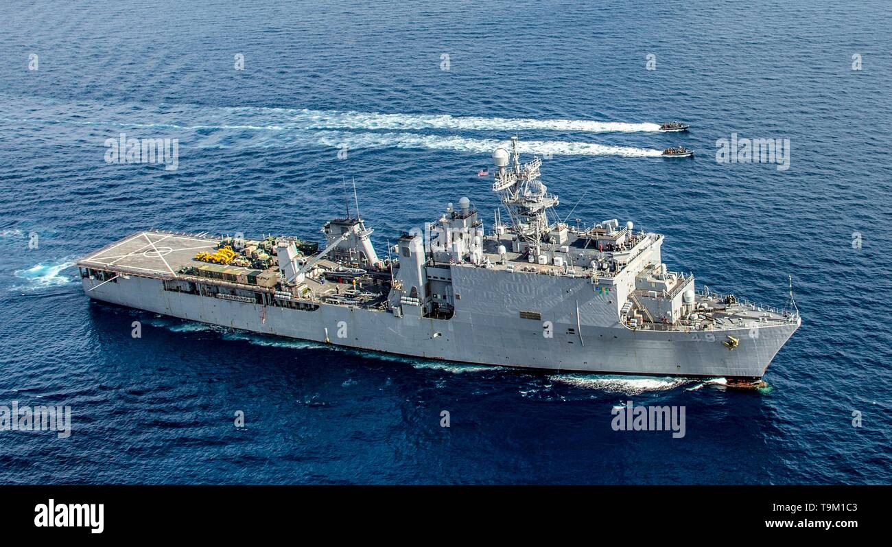 Dock aterrizaje anfibio de la Marina de los EE.UU buque USS Harpers Ferry, proporciona el ocultamiento para dos botes inflables de casco rígido durante una visita, junta, búsqueda e incautación de entrenamiento de operaciones, 19 de marzo de 2019 en el océano Pacífico oriental. Foto de stock