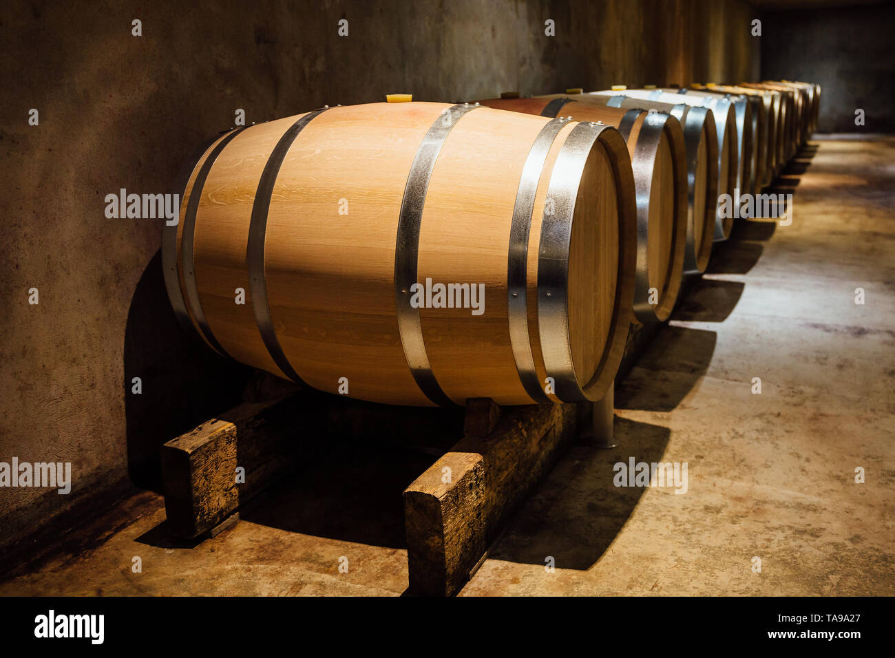 Maduración en barriles de roble de vino en una bodega. Foto de stock