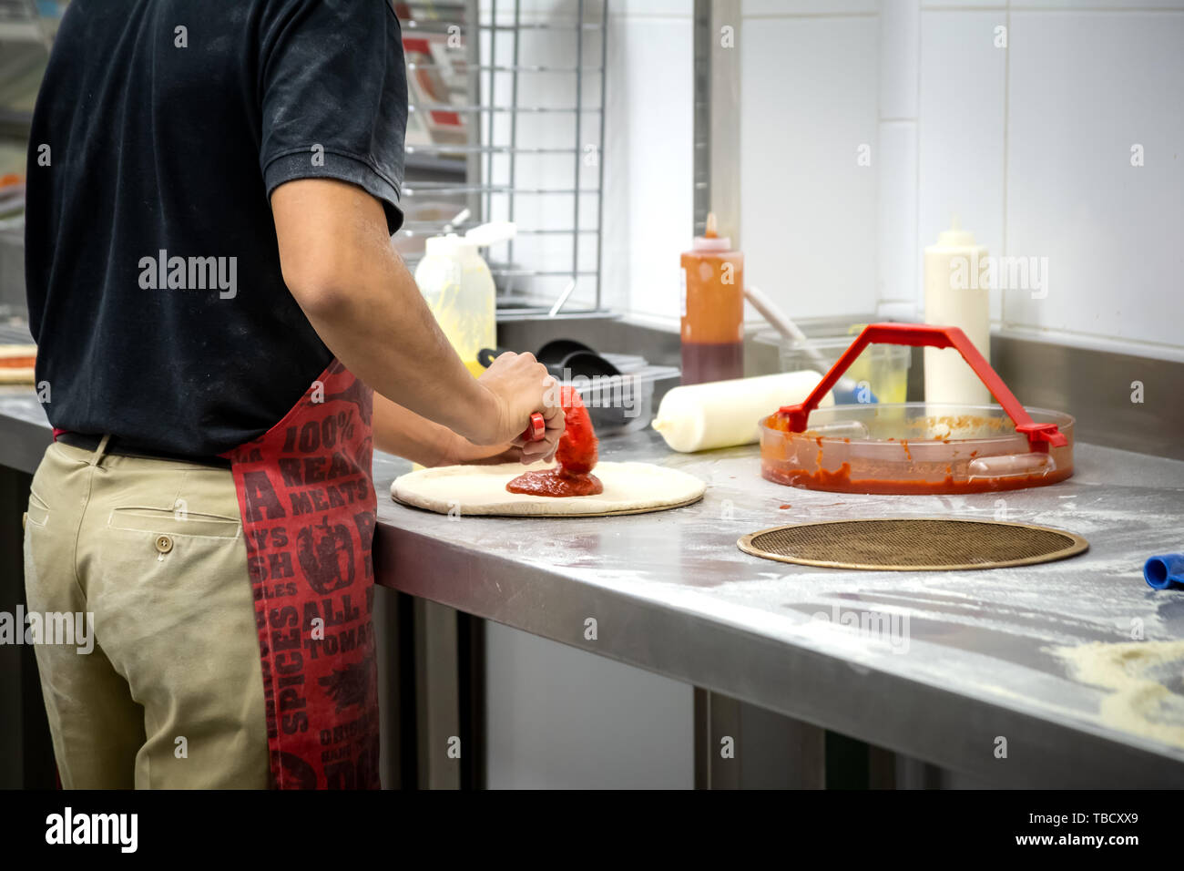 Cocinar la masa por las manos de los hombres en un restaurante de pizza Foto de stock