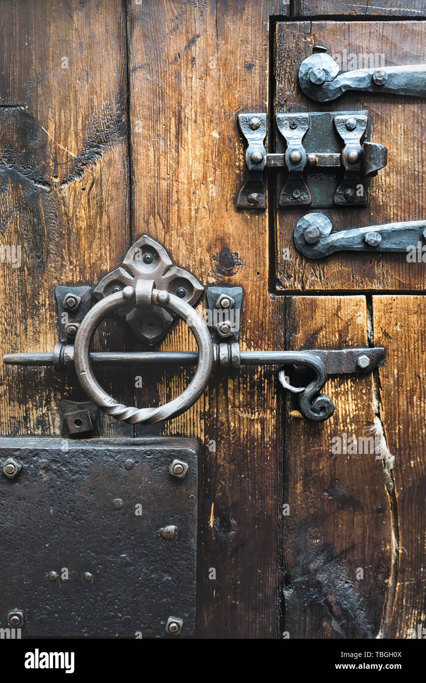 Puerta de madera con muebles antiguos de hierro forjado, cerraduras y