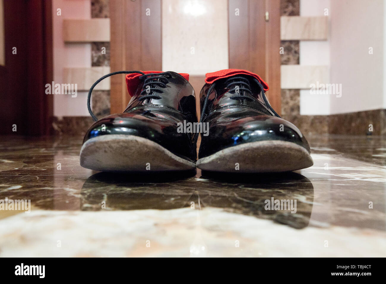 Charol negro zapatos con cordones y calcetines rojos en el interior, están  en el piso de mármol negro, primerísimos Fotografía de stock - Alamy