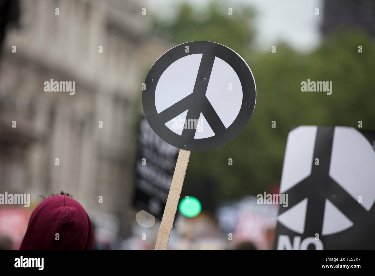 Una persona tiene un signo de paz banner en una protesta Foto de stock