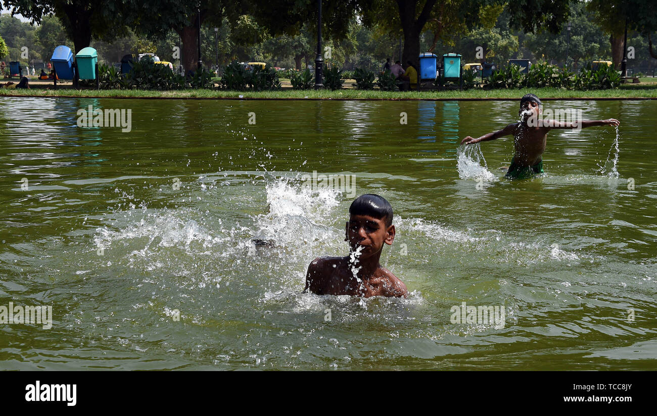 Nueva Delhi, India. El 7 de junio de 2019. Los niños juegan con agua en una  piscina en Nueva Delhi, India, 7 de junio de 2019. Ola de calor se ha  intensificado