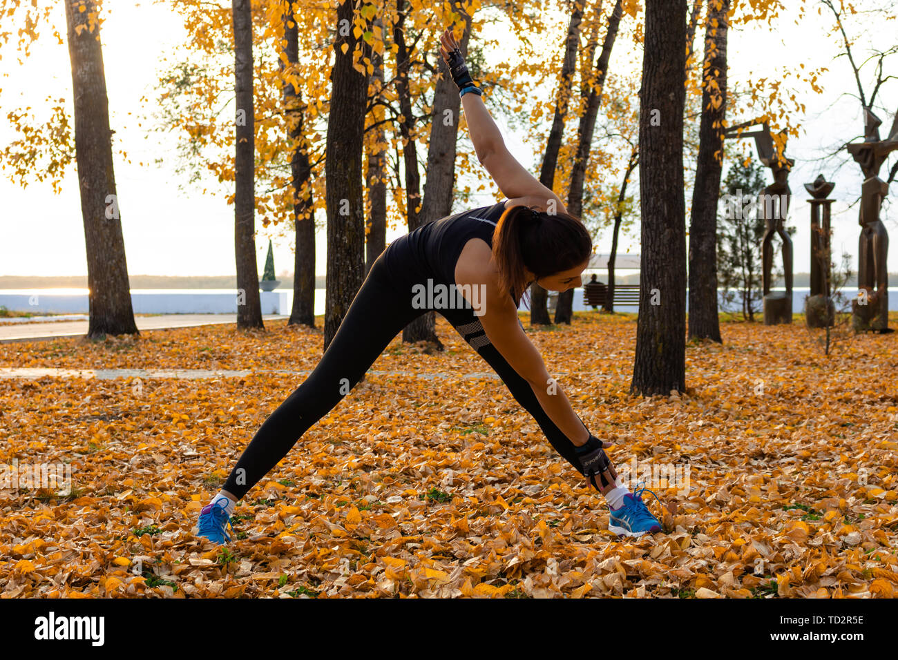 Jabarovsk, Rusia - 07 Oct, 2018: una mujer atractiva en ropa deportiva  haciendo ejercicios deportivos en la naturaleza frente a la puesta del sol  y el río Amur, AMA Fotografía de stock - Alamy