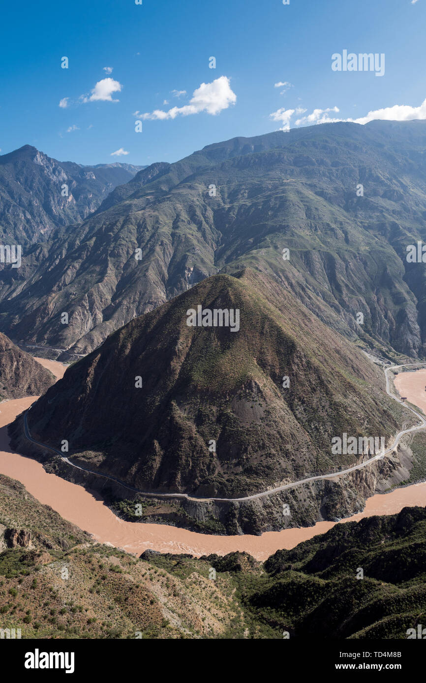 La primera curva del río Jinsha (como el gran giro del Río Yaruzangbo es también conocida como la curva) a través de la montaña a través del valle del río Jinsha, como consecuencia de ello, la tendencia del agua es aún más vasto, el cañón se abre gradualmente, cuando va a salir de esta fortaleza Sichuan-Yunnan parece querer aliviar la fatiga de la larga distancia ejecuta en primer lugar, por lo que ralentiza y bellamente dibuja un gallardo alrededor de la pirámide-como el Día Pico de cono " Omega " un gran cambio en la forma. Inesperadamente, este involuntario ha logrado un espectáculo de improvisación. Foto de stock