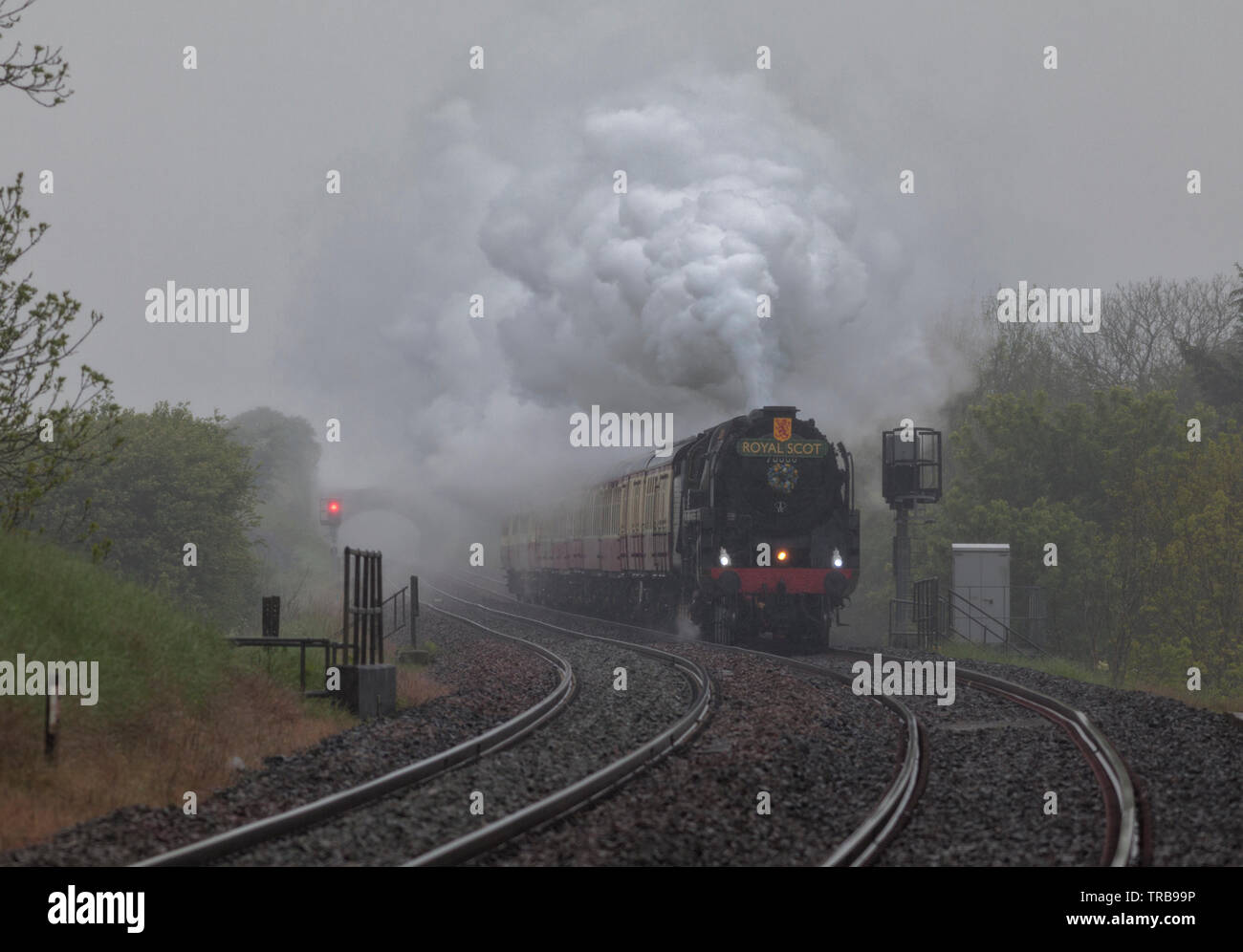 Locomotora de vapor 70000 Britannia pasando Horton en Ribblesdale en liquidar a Carlisle railway en Heavy Rain con sapos railtour Foto de stock