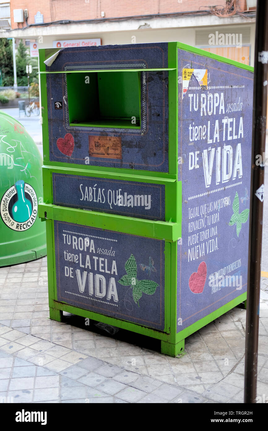 Donación de ropa bin en una calle de Granada, España; el texto sobre la  bandeja dice 'ropa usada tiene la trama de la vida" para fomentar la  donación de ropa Fotografía de