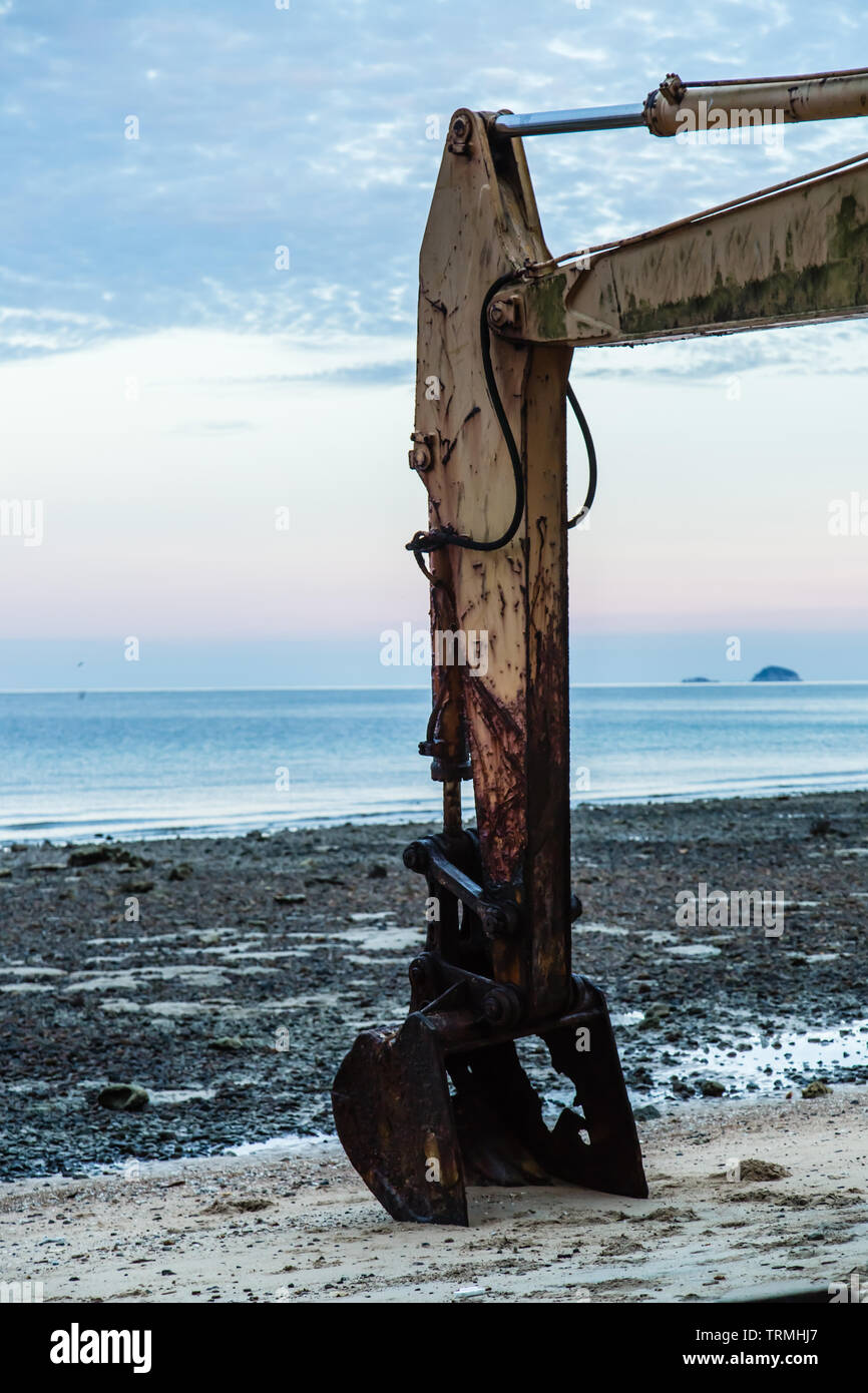 Abandonados oxidados y viejos excavadora en la playa Foto de stock