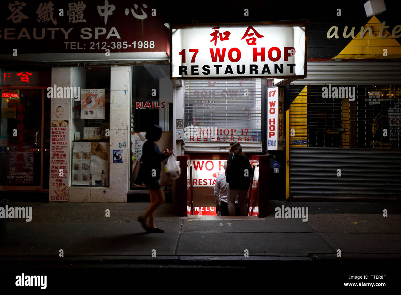 Wo Hop, 17 Mott Street, New York, NY. noche escaparate exterior de un restaurante chino Chinatown de Manhattan. Foto de stock