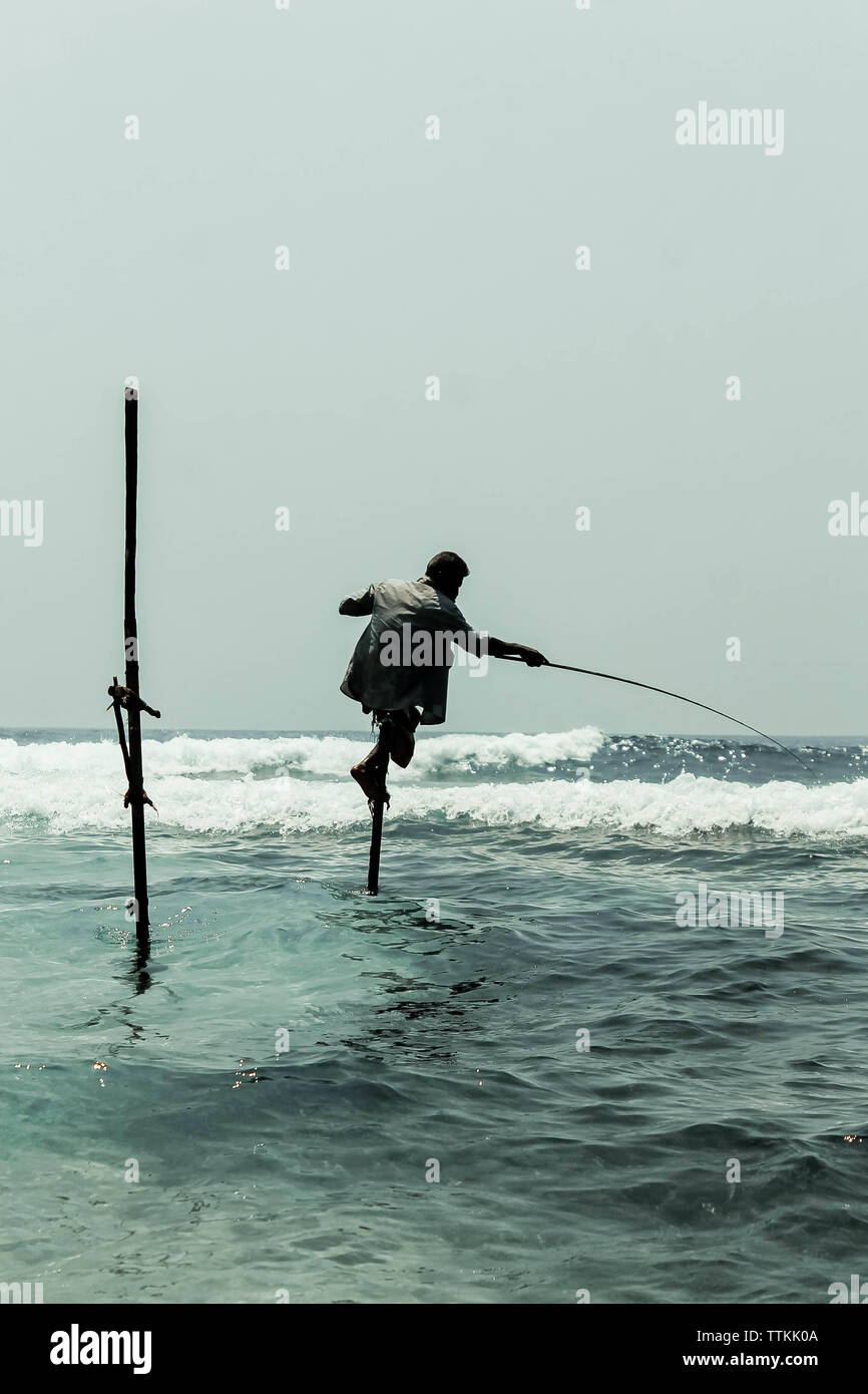 Un pescador local en Sri Lanka está sentado en una percha en el agua y  Fotografía de stock - Alamy