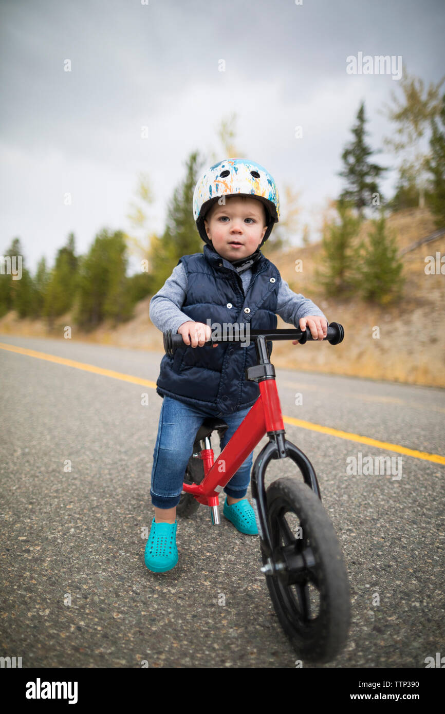 Bebé En Casco Que Aprende Montar En La Bici Foto de archivo - Imagen de  equilibrio, disfrutar: 16931588