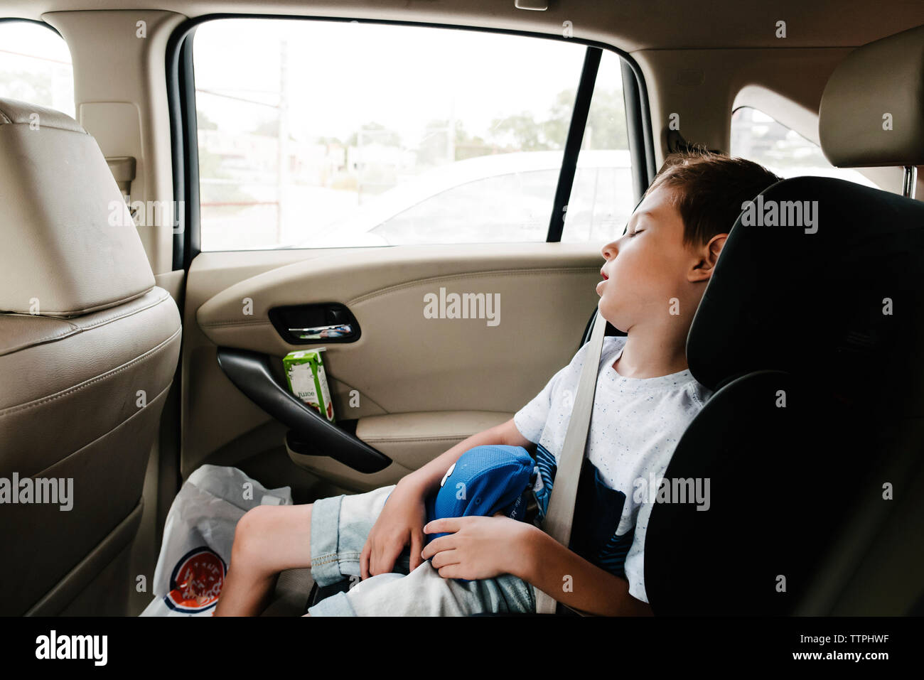 Niño durmiendo en el coche Foto de stock