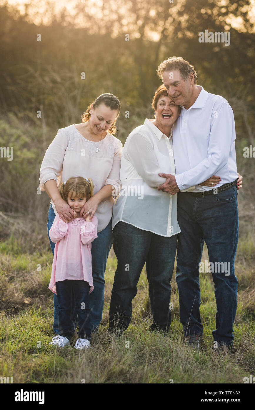 Familia multigeneracionales abrazar en el campo Foto de stock
