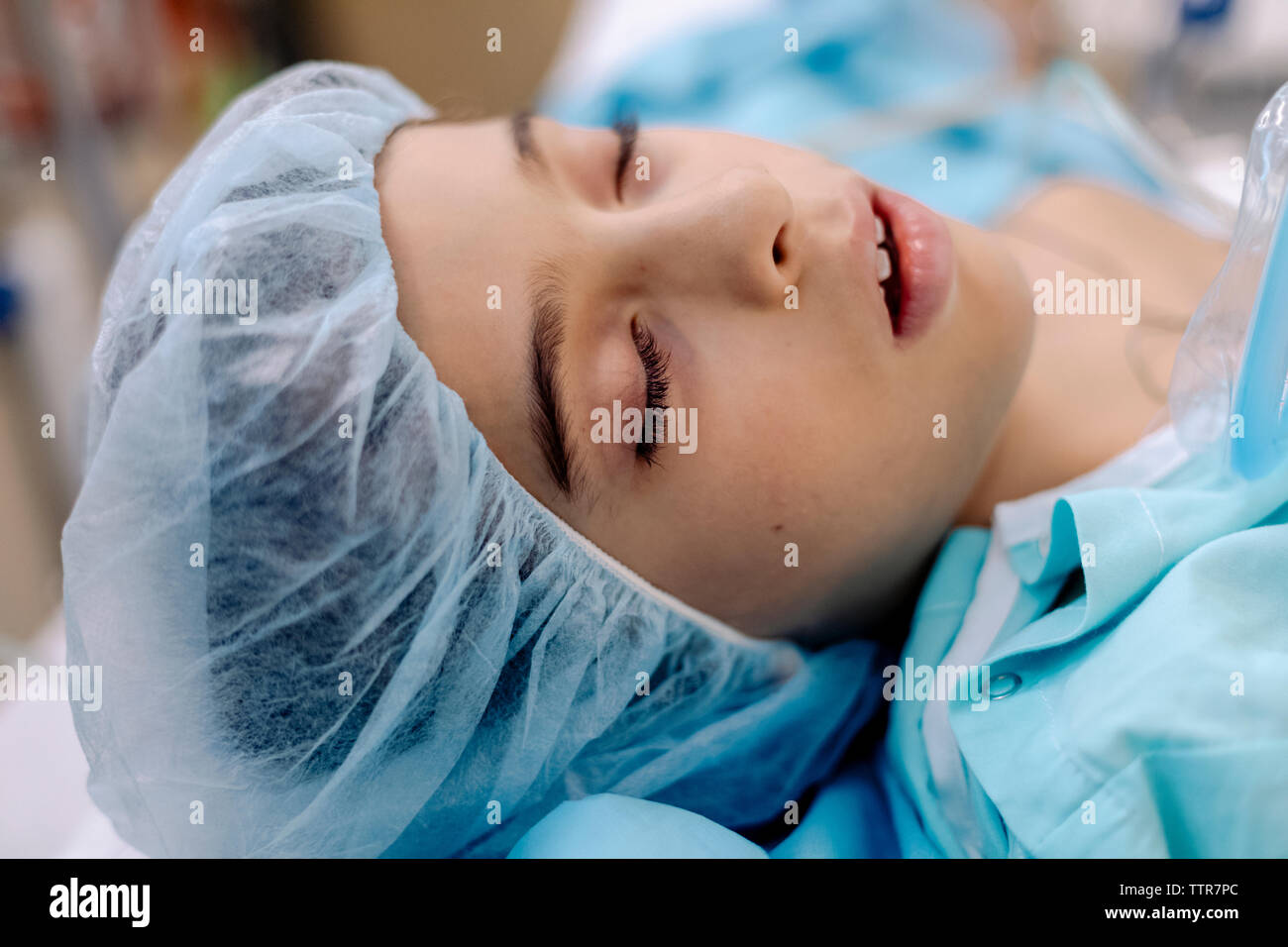Primer plano de un niño con los ojos cerrados en el hospital y birrete Foto de stock