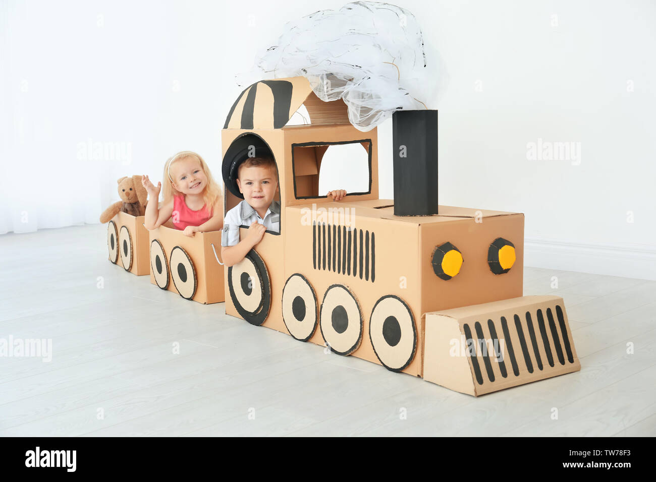 Pequeños Niños Jugando Con Tren De Cartón En La Luminosa Sala Fotografía De Stock Alamy 