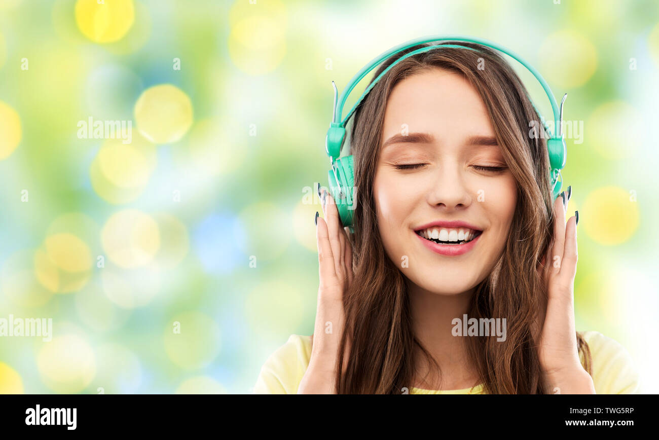 Feliz joven o adolescente con auriculares Foto de stock