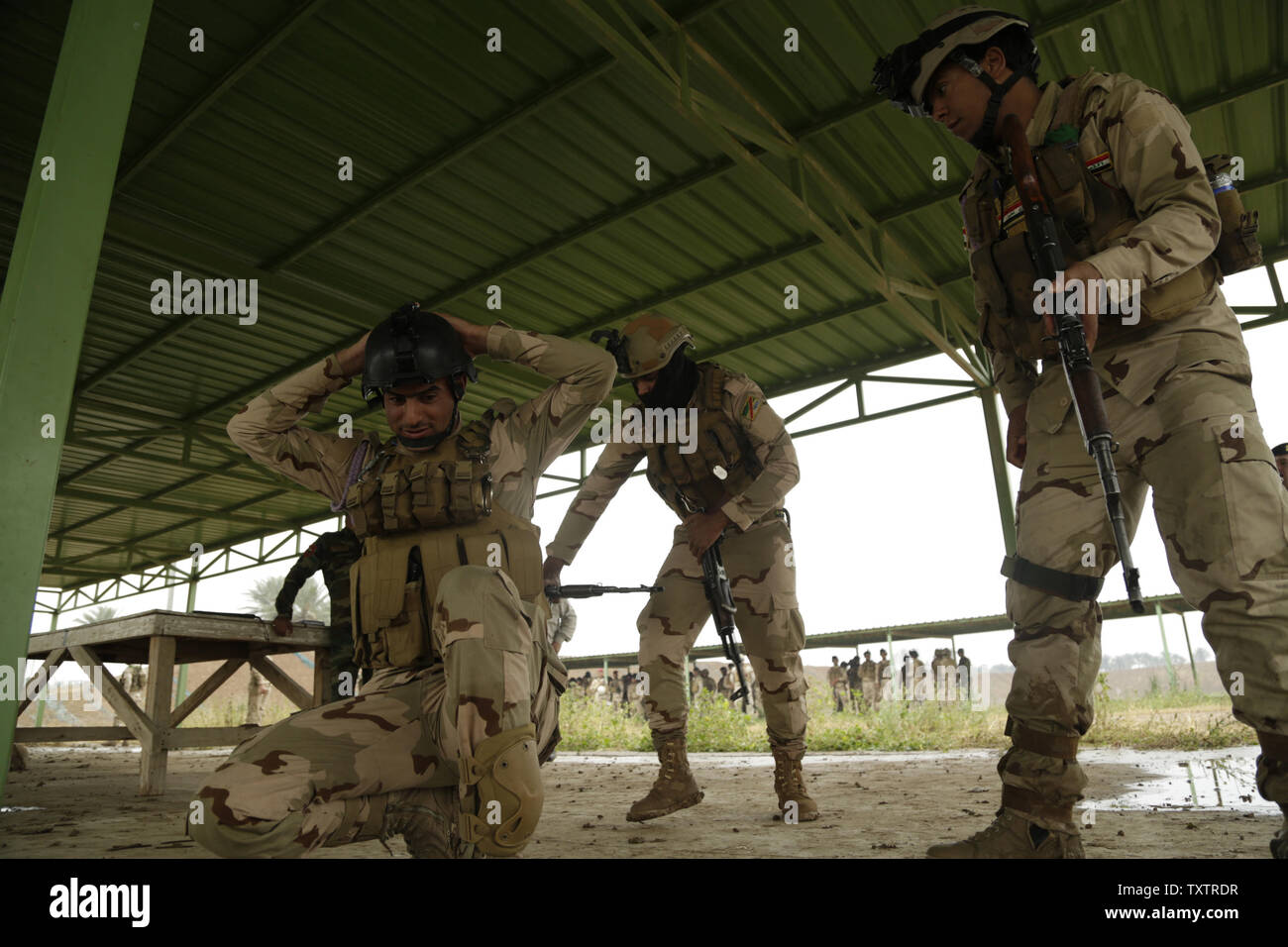 Los soldados iraquíes con el 4º Batallón, 23ª Brigada del ejército iraquí, practicar buscando un detenido durante una evaluación de habilidades en Camp Taji, Iraq, el 28 de marzo de 2016. El Grupo de Tareas de Taji, realizó la evaluación de habilidades para medir la aptitud soldiersÕ en combate básico tareas. A través de asesorar y ayudar, y construyendo la capacidad del partner misiones, la Combined Joint Task Force C Funcionamiento inherentes ResolveÕs coalición multinacional ha capacitado a más de 19,9K personal para derrotar el estado islámico de Irak y el Levante. Foto por Sgt. Pablo Venta/EE.UU. Ejército/UPI Foto de stock