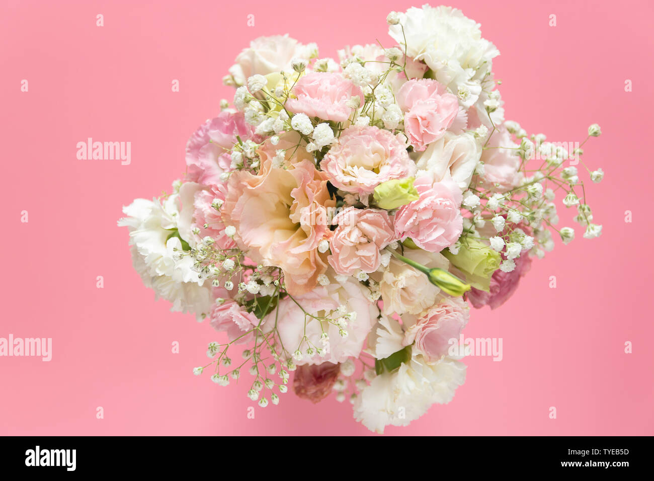 Vista superior del bonito y romántico ramo de flores frescas sobre fondo de color rosa con espacio de copia Foto de stock