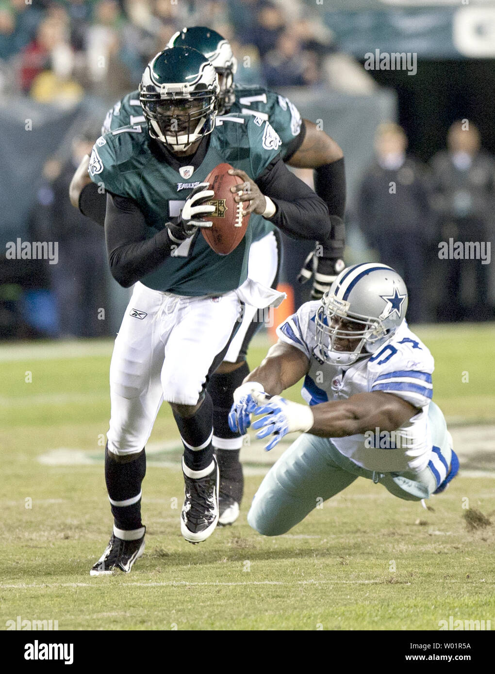 The Philadelphia Eagles' Michael Vick (7) runs for a first down as the New  York Jets' Howard Green, left, and Kenwin Cummings, right, chase during  first quarter action at Giants Stadium in