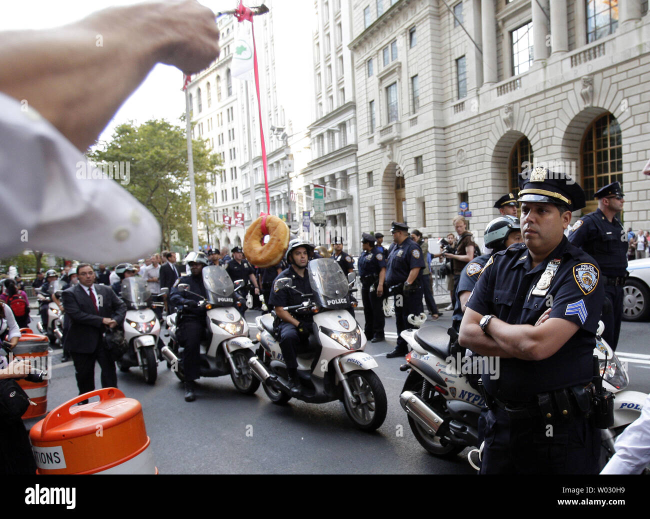 Un manifestante Occupy Wall Street cuelga un donut delante del NYPD  policías cerca de la Bolsa de Valores de Nueva York, en la Ciudad de Nueva  York el 17 de septiembre de