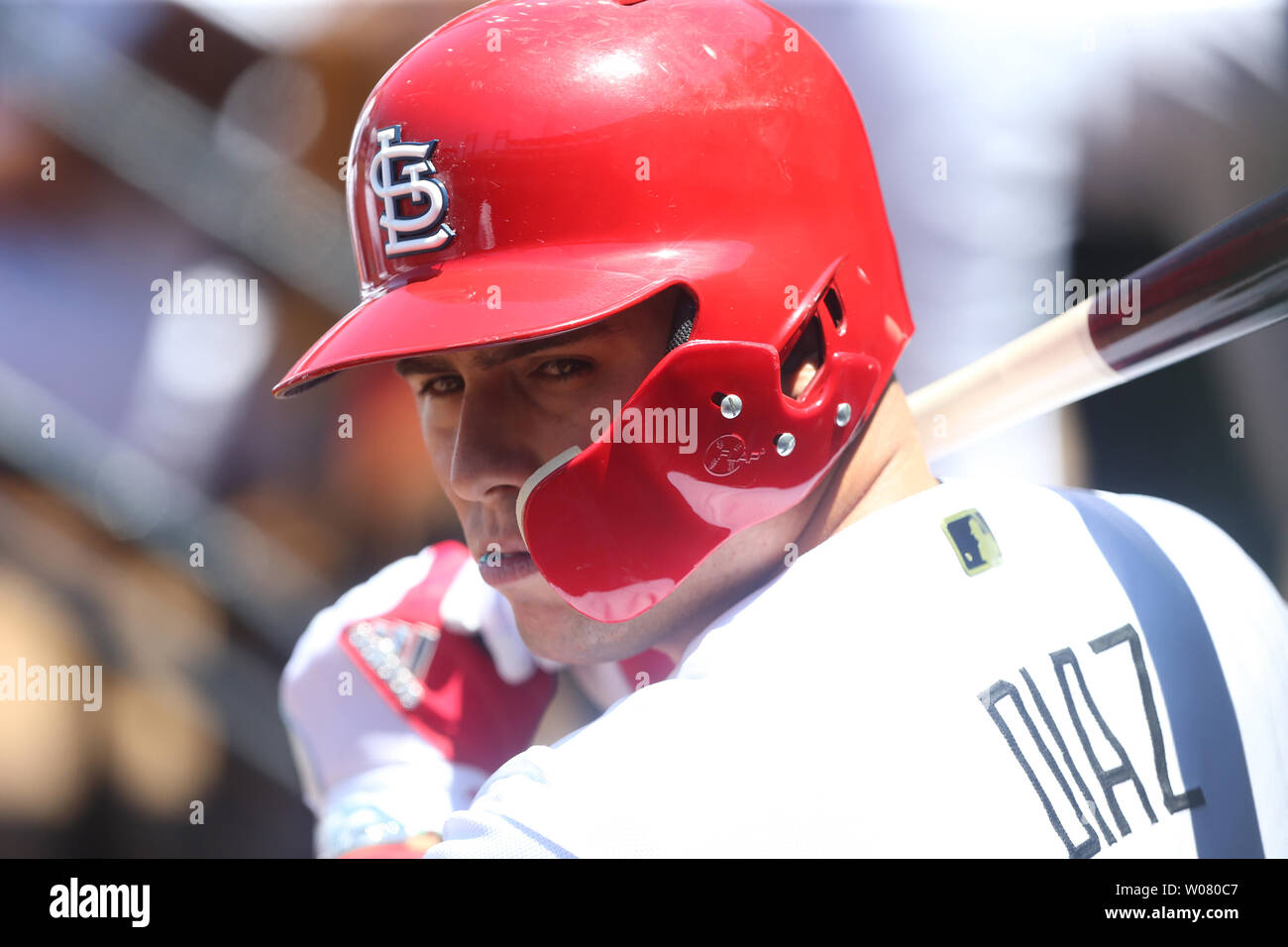 St. Louis Cardinals Aledmys Diaz retrieves a Jose Fernandez shirt that hung  in the dugout for their game against the Cincinnati Reds at Busch Stadium  in St. Louis on September 27, 2016.