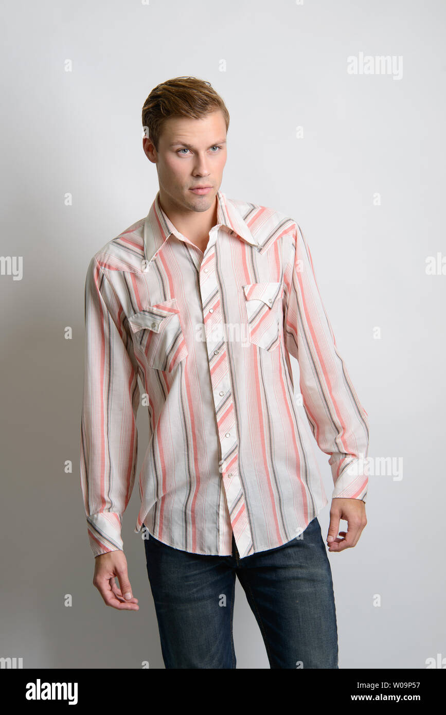 Un modelo macho caucásico de pelo marrón se presenta en una camisa de rayas  vintage, un editorial de moda vintage de hombre Fotografía de stock - Alamy