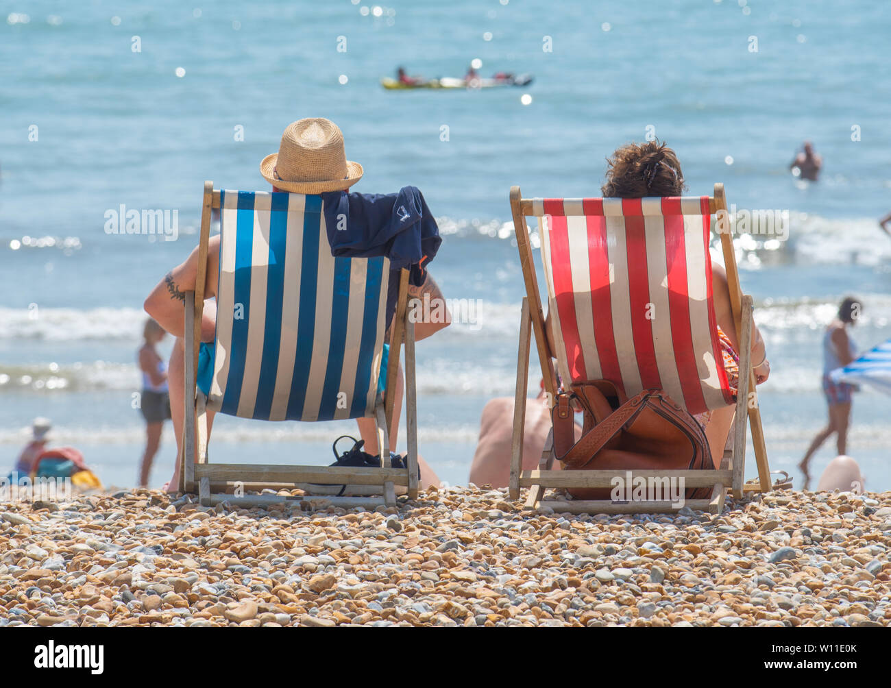 Lyme Regis, Dorset, Reino Unido. El 29 de junio de 2019. El clima del Reino Unido: una pareja de ancianos, relajarse en las tumbonas de sol abrasador en la última semana del año hasta la fecha. Fue el más caluroso de junio en el registro. Crédito: Celia McMahon/Alamy Live News. Foto de stock