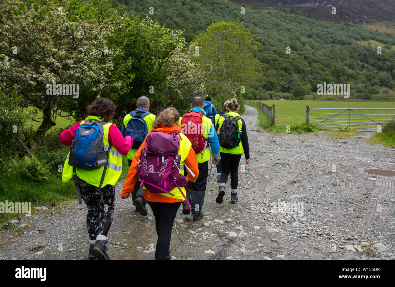 Vestían Chaquetas de alta visibilidad turistas paseando en Buttermere en el Lake District. Foto de stock