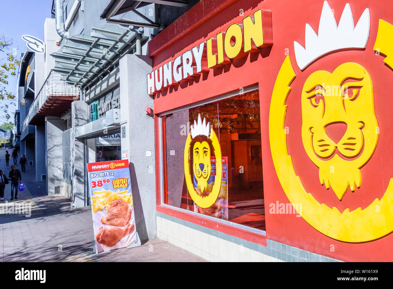 León hambriento tienda de pollo frito en Windhoek, Namibia Foto de stock