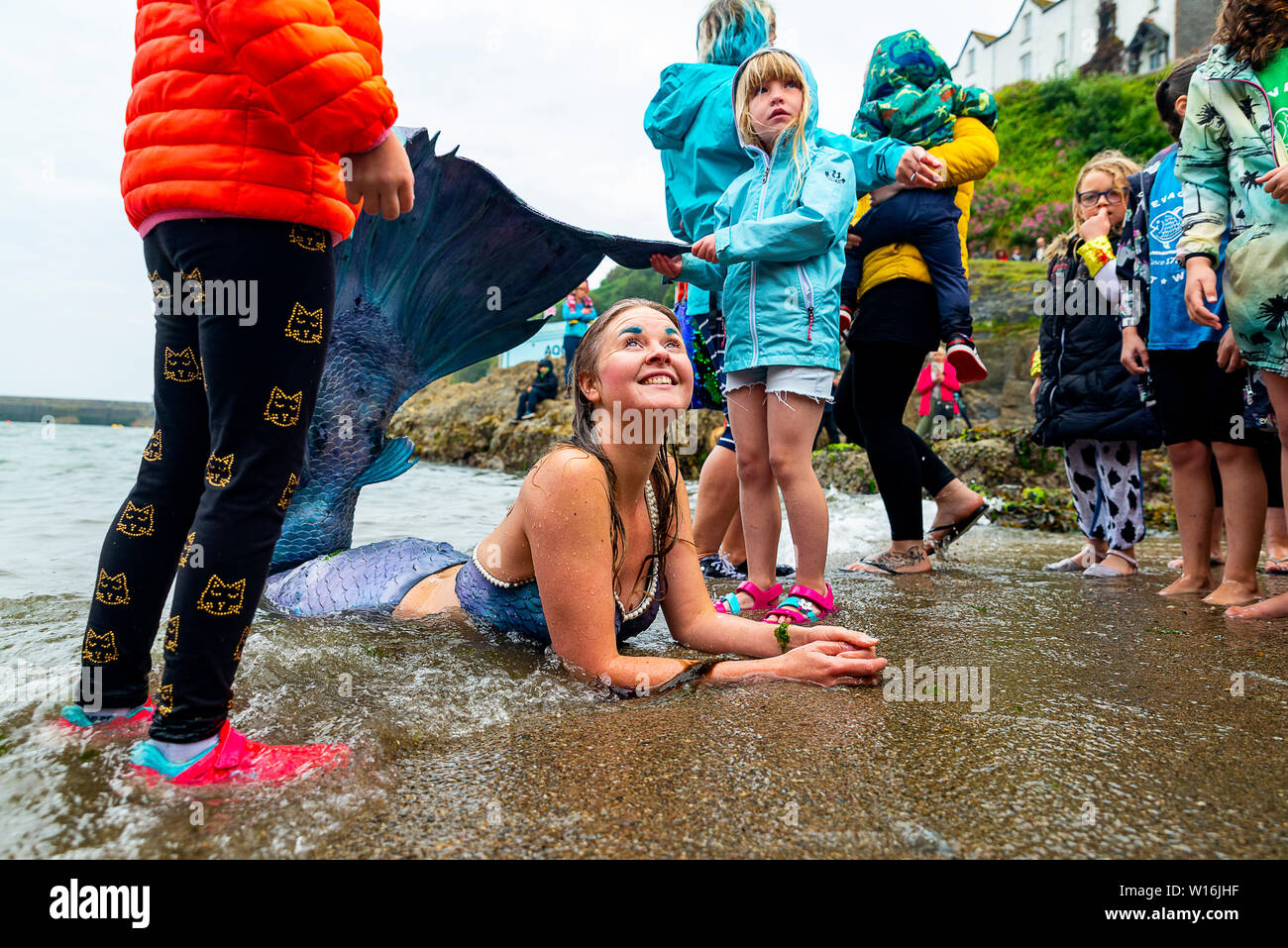 Editorial: Mevagissey, Cornualles, en el Reino Unido. 23/06/2019 Professional mermaid Laura Evans emociona a jóvenes y viejos como "lavados" en Mevagissey Harbour. Foto de stock