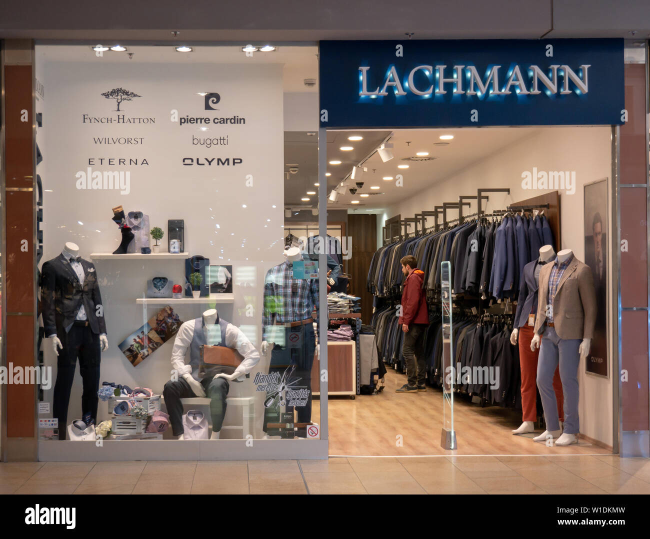 Gyor Hungría 05 07 2019 Un joven comprador buscando ropa en una tienda lachmann Foto de stock