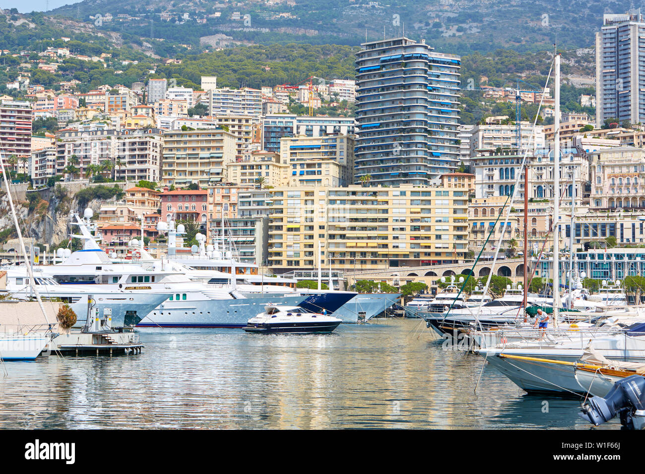 MONTE CARLO, Monaco - Agosto 20, 2016: puerto de Monte Carlo con barcos y yates de lujo, fondo de la ciudad en un día de verano en Montecarlo, Mónaco. Foto de stock