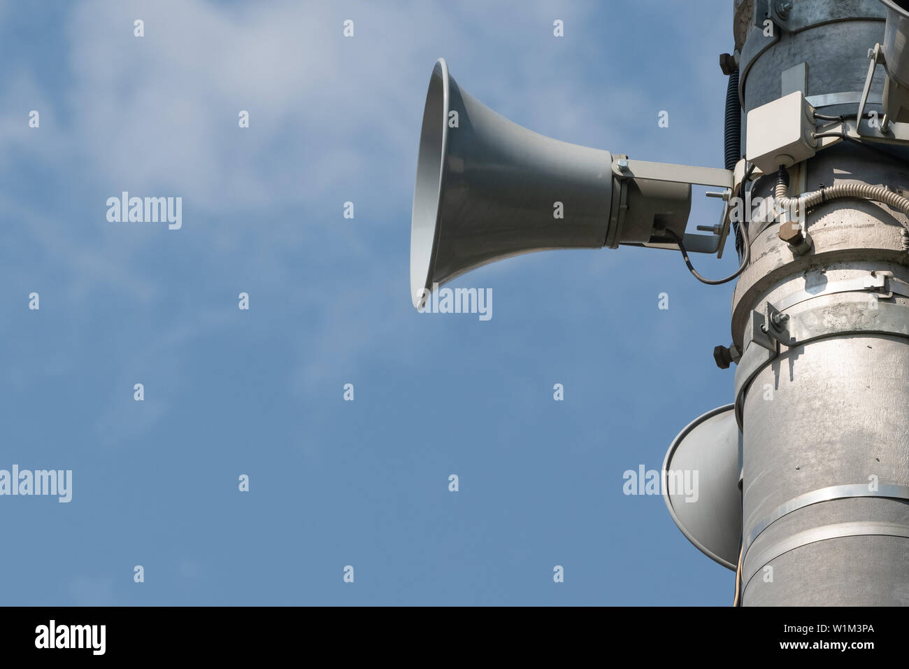 Descripción: tres altavoces en la pole contra el cielo azul Foto de stock