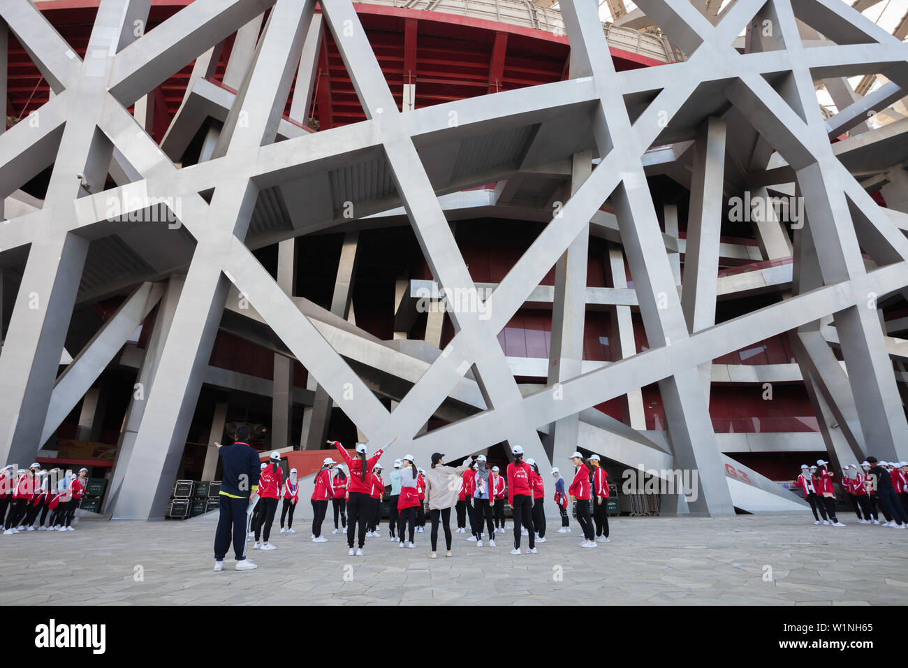 Un grupo de niñas jóvenes antes de que el rendimiento del tren en la parte delantera de nido de pájaro stadion en el Parque Olímpico, Beijing, China Foto de stock
