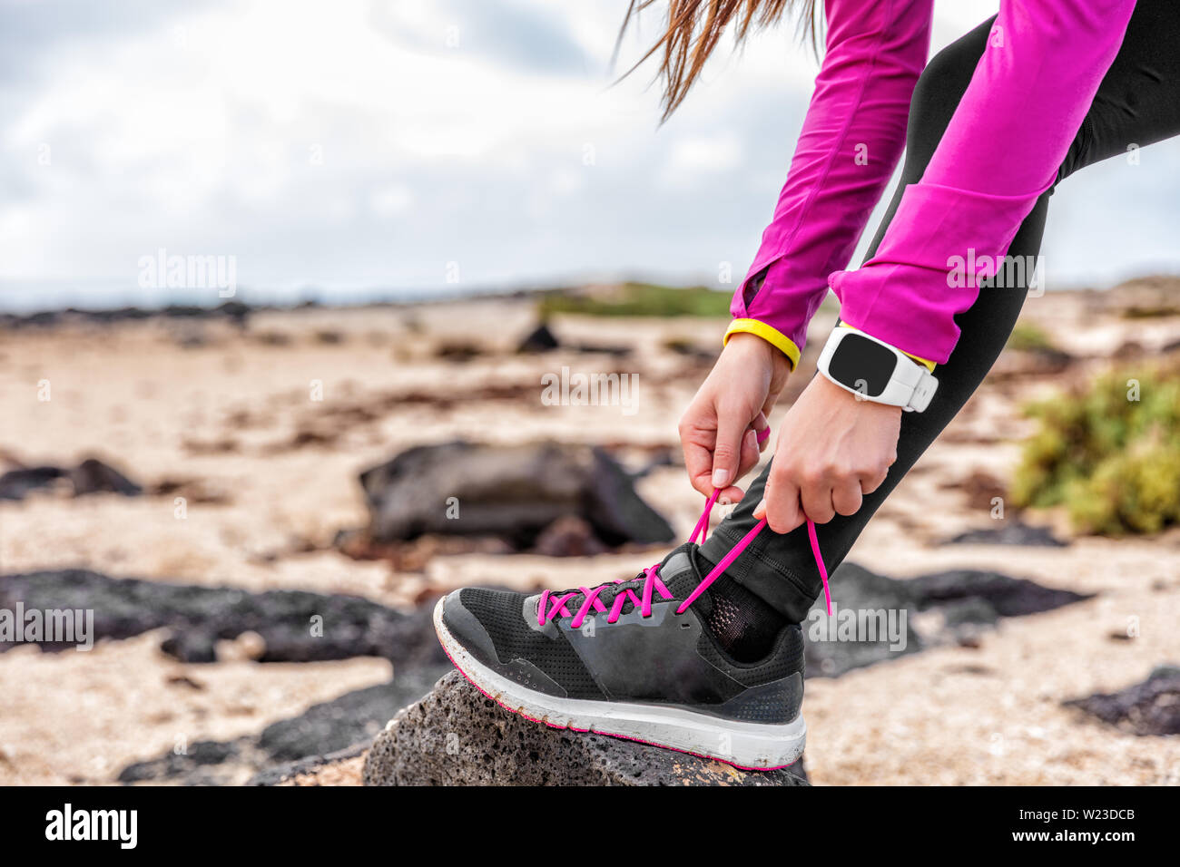 Smartwatch Fitness mujer runner zapatillas de costura en Playa Chica, un  atleta preparándose para ejecutar entrenamiento Running Shoe Cordones de  atado fuera vistiendo watch marcha. Concepto de estilo de vida saludable  Fotografía