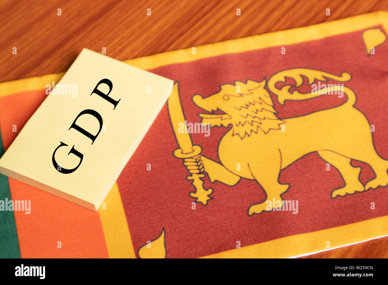 La palabra producto interno bruto o PIB escrito en papel sobre la bandera de Sri Lanka. Foto de stock